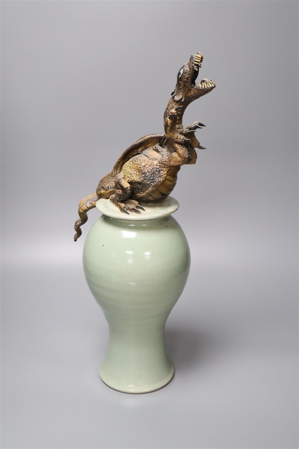 A Chinese celadon vase and cover having later cold-painted metal dragon terminal (repair)